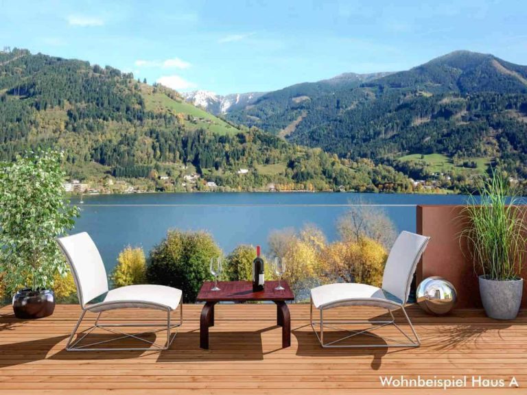 Terrasse mit Blick auf Zeller See, moderne Möbel, idyllische Berglandschaft im Hintergrund.
