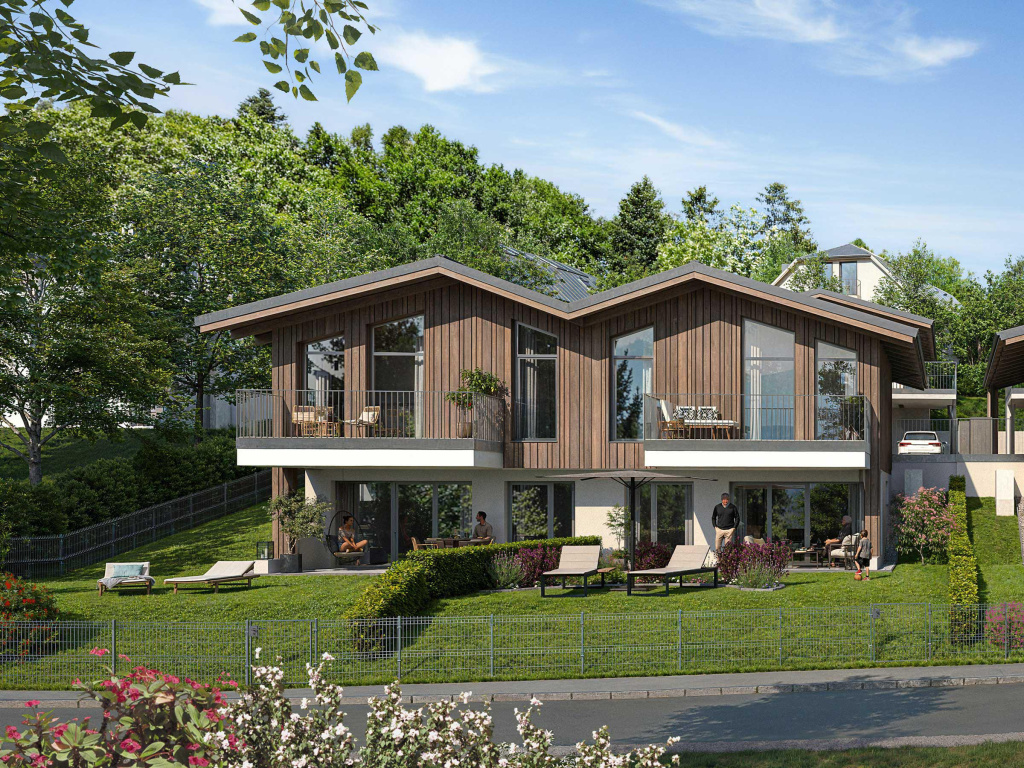 Moderne Wohnhäuser mit Holzfassade, Balkonen und Garten am grünen Hang