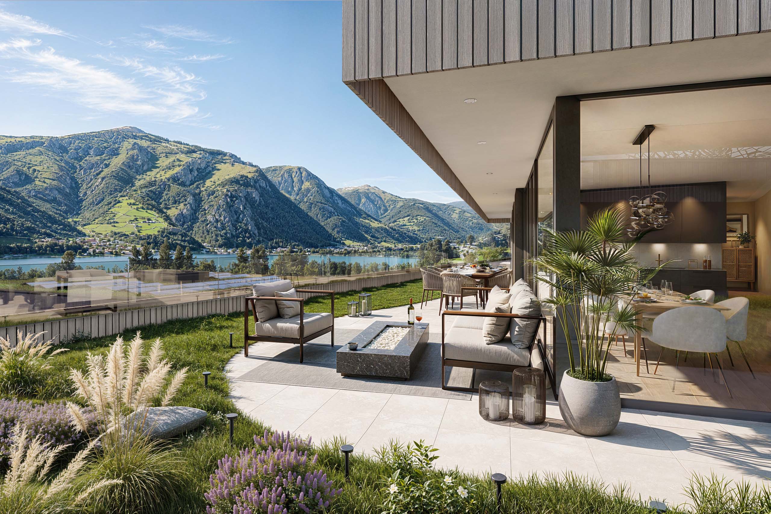 Möblierte Terrasse mit Garten, Seeblick und bewaldeten Bergen vor einem modernen Wohnhaus